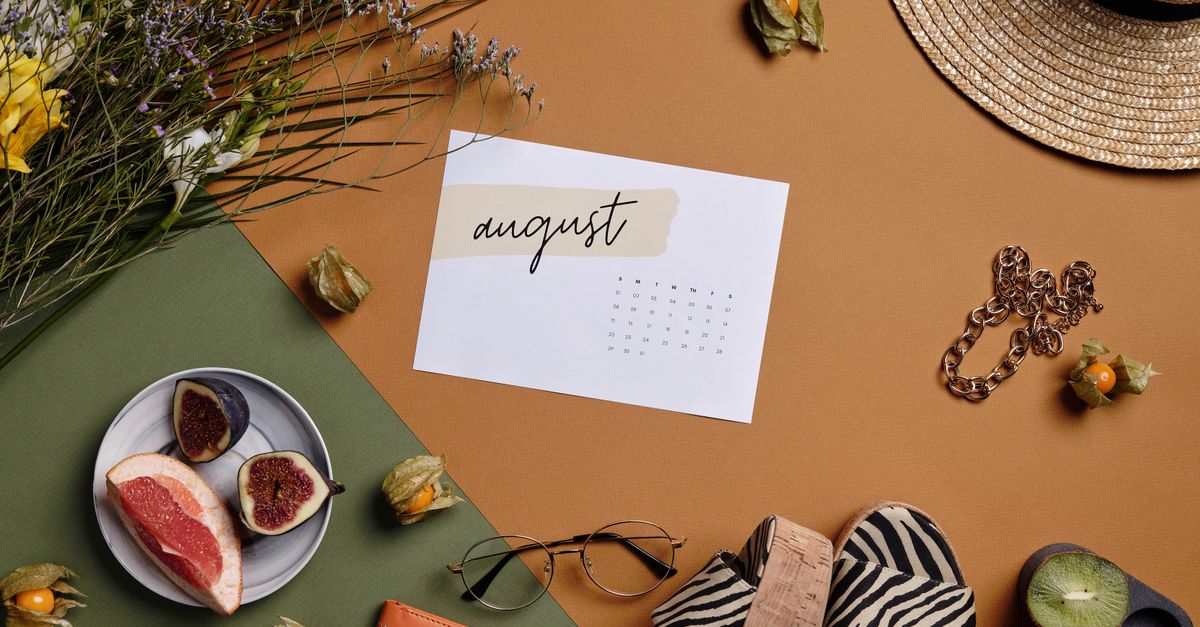Aesthetic summer arrangement with fruits, flowers, and August calendar.